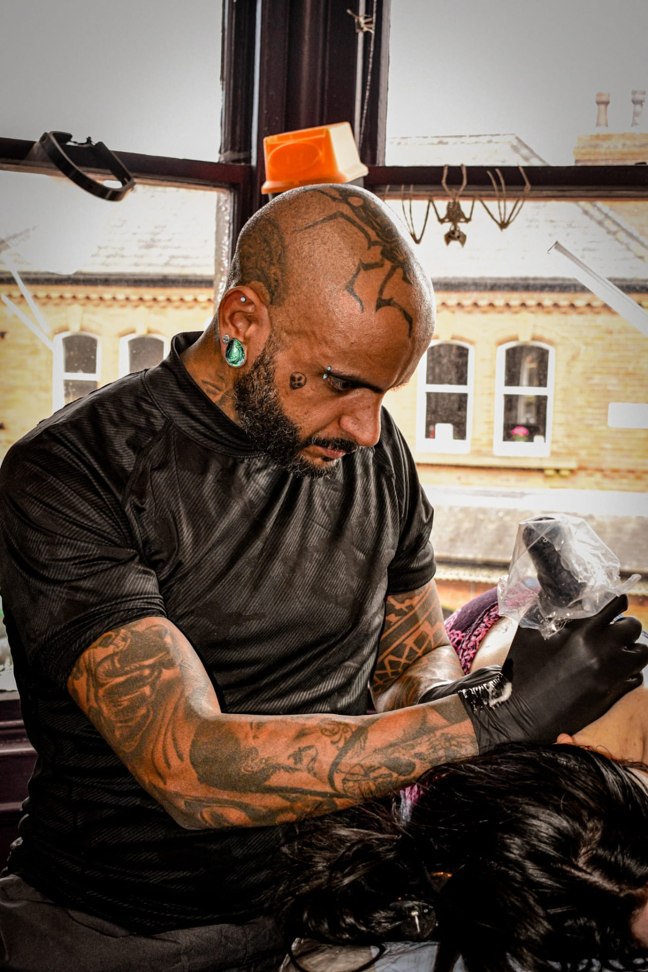 Tattooing a client at House of Hoodoo Tattoo Studio