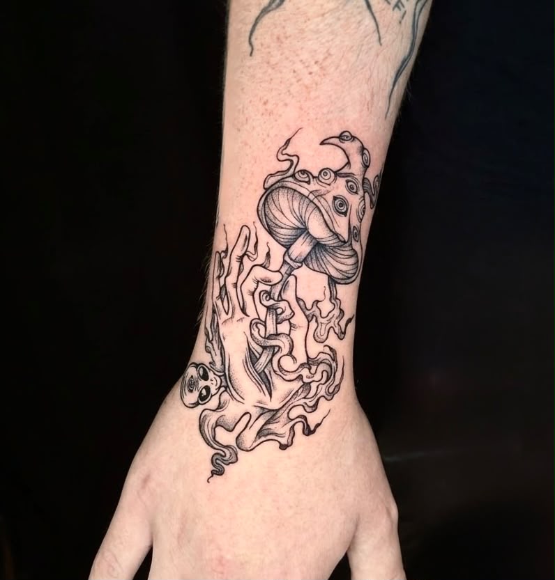Mushroom and flames hand tattoo