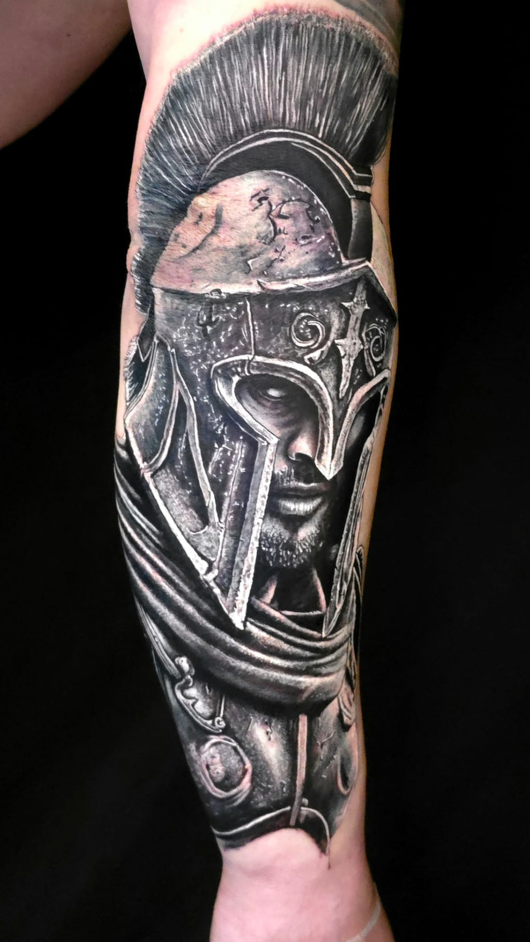 Black-and-grey Spartan warrior forearm tattoo